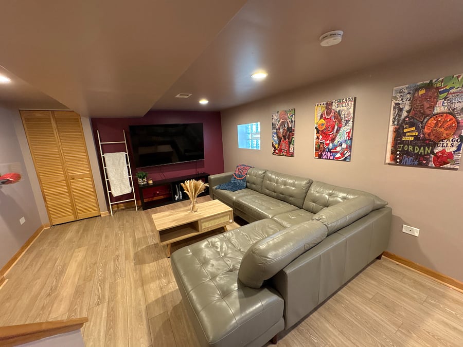 A 2nd Living space with 75" TV, workstation, Laundry, and Bedroom