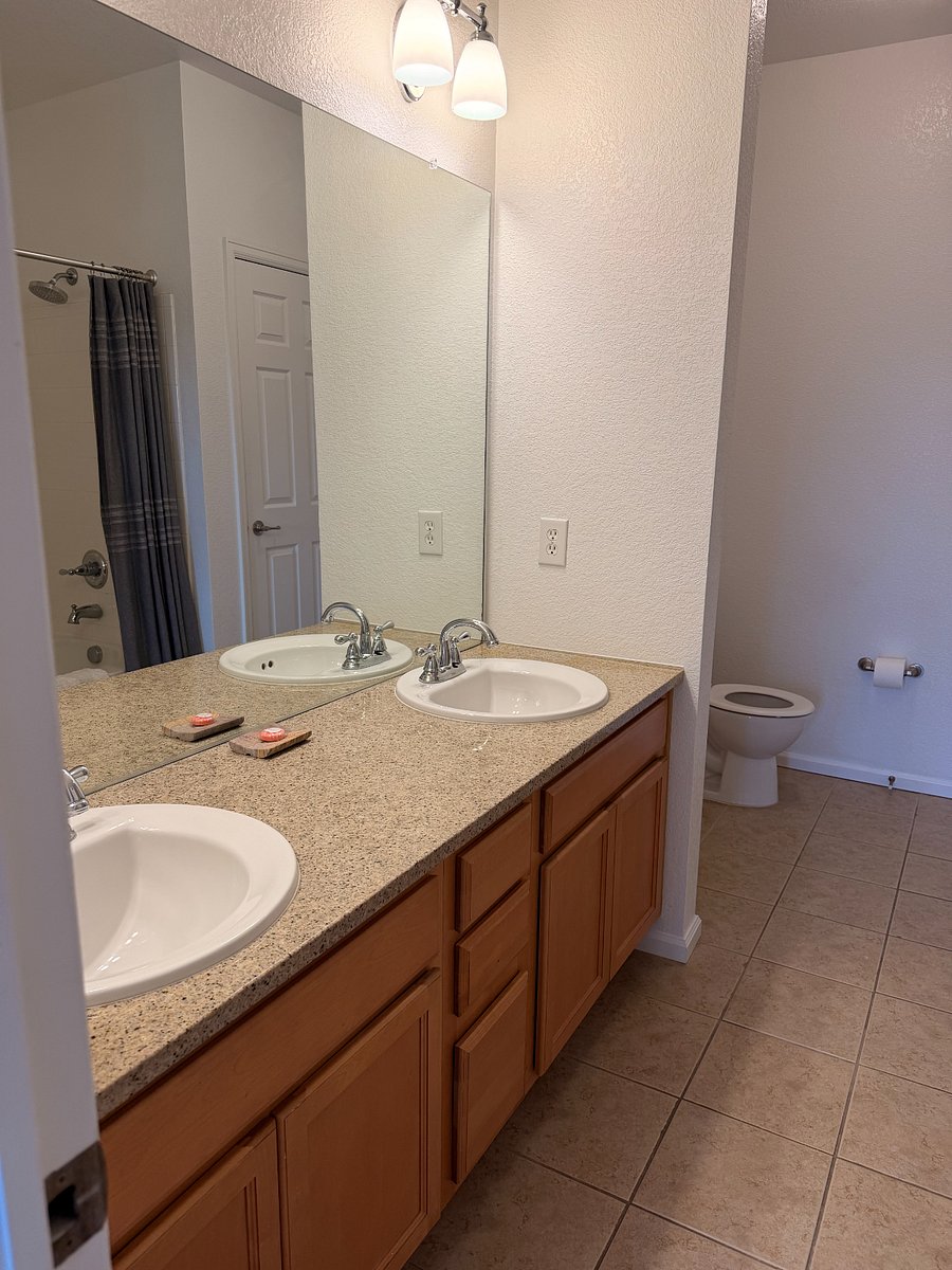 Main bedroom ensuite bathroom with double sinks and granite countertops