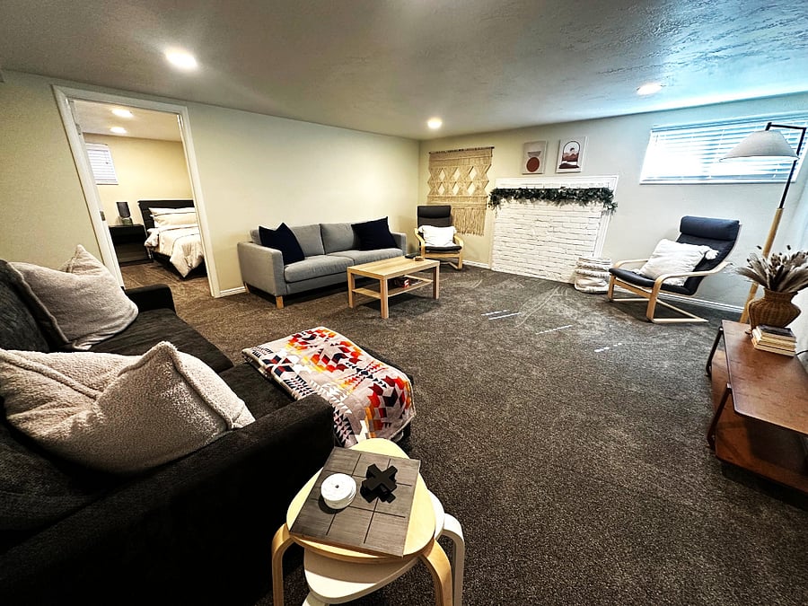 Living room with sofa, chairs, table, and sofa bed.
