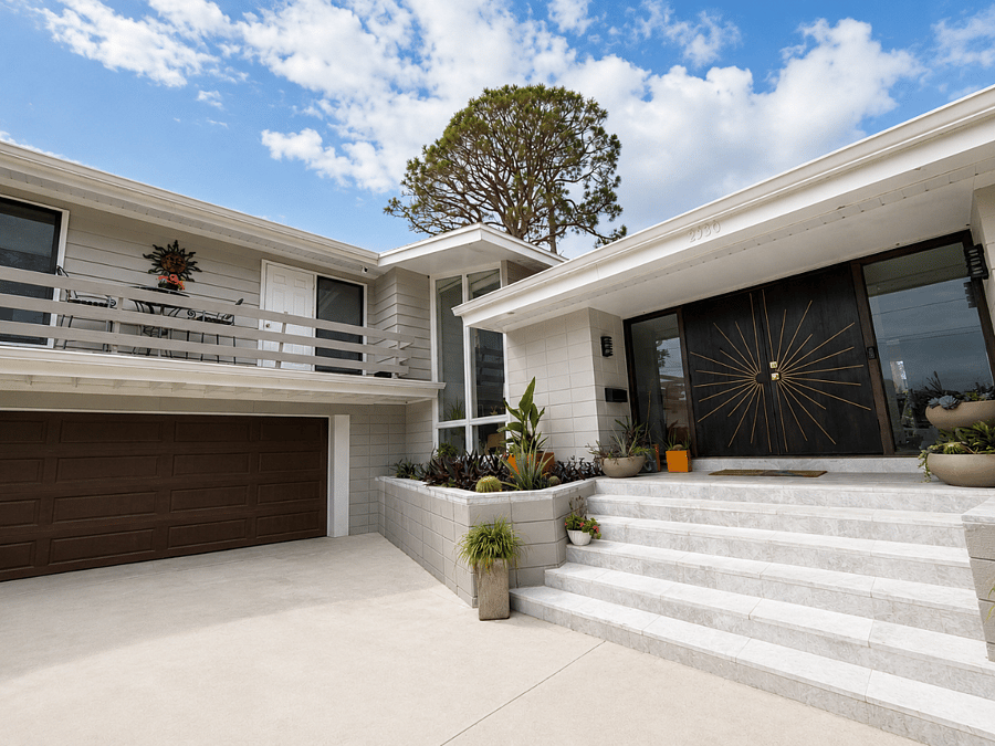 Two-story windows. Beautiful stone steps, leading to a custom sunburst door. Balcony number 1 is conveniently located from the upstairs hall. A large two car garage with workbench and plenty of storage space. 