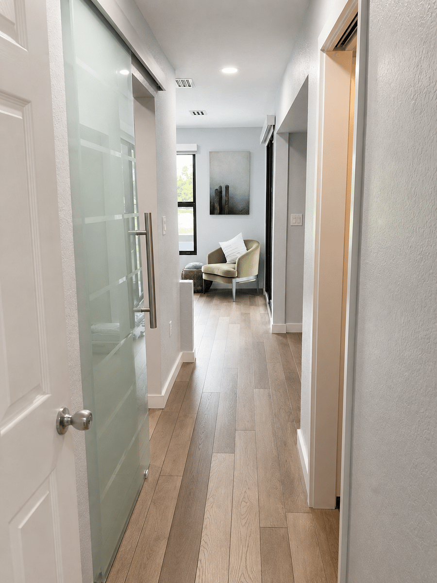 Entry to the Master Suite with a custom glass barn door leading you into a spa-like retreat. 