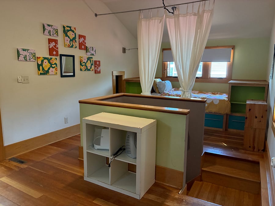 Upstairs, the stairwell opens up to two twin beds and lots of storage under the dormers. Included is a humidifier and space heater (seen in cube storage).