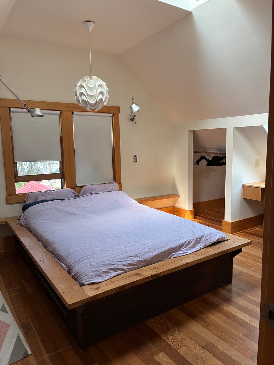 Master bedroom, full of natural light from skylights and windows.