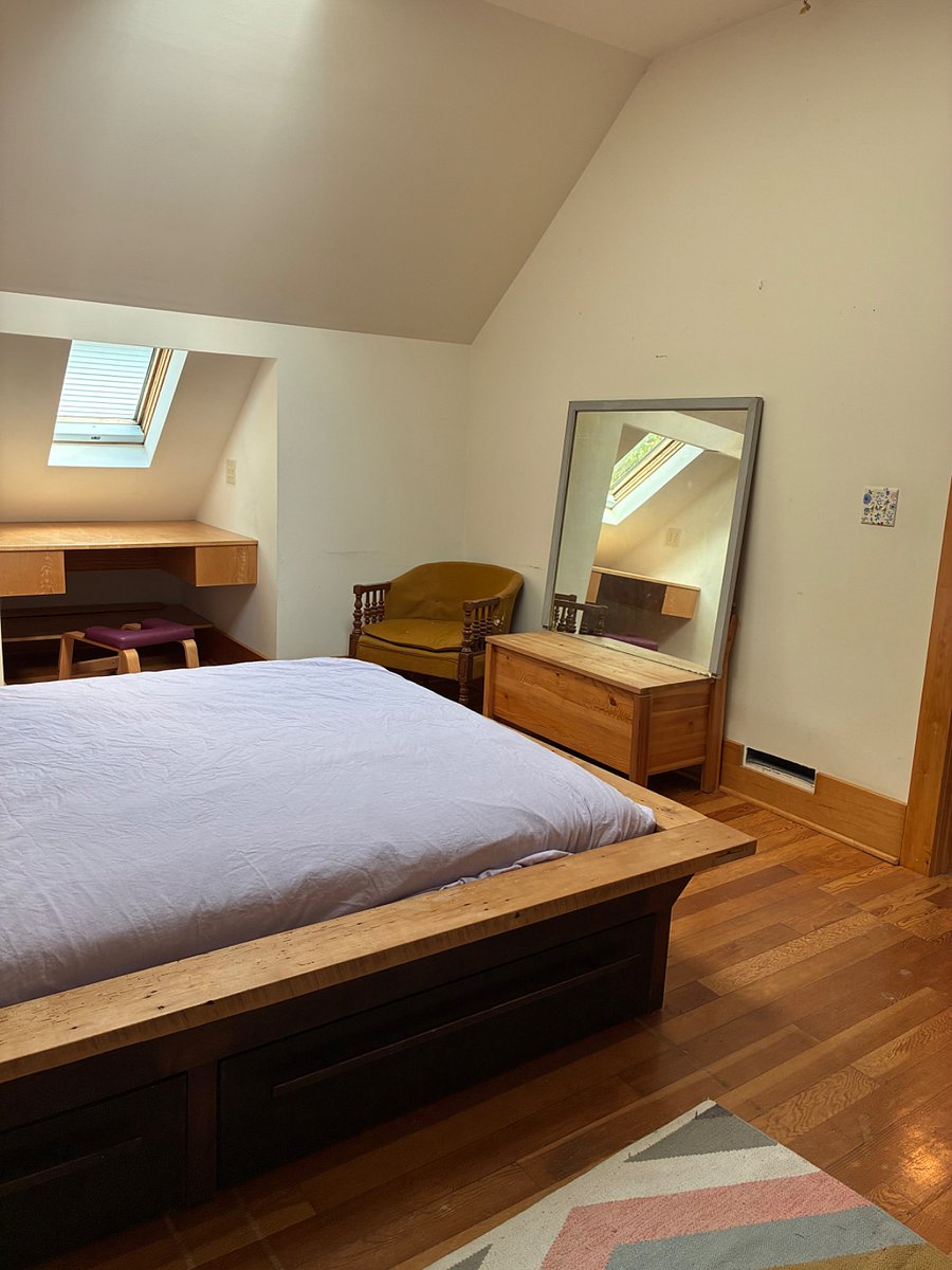 Built-in storage under the king-sized master bed and sunny desk under the skylight.