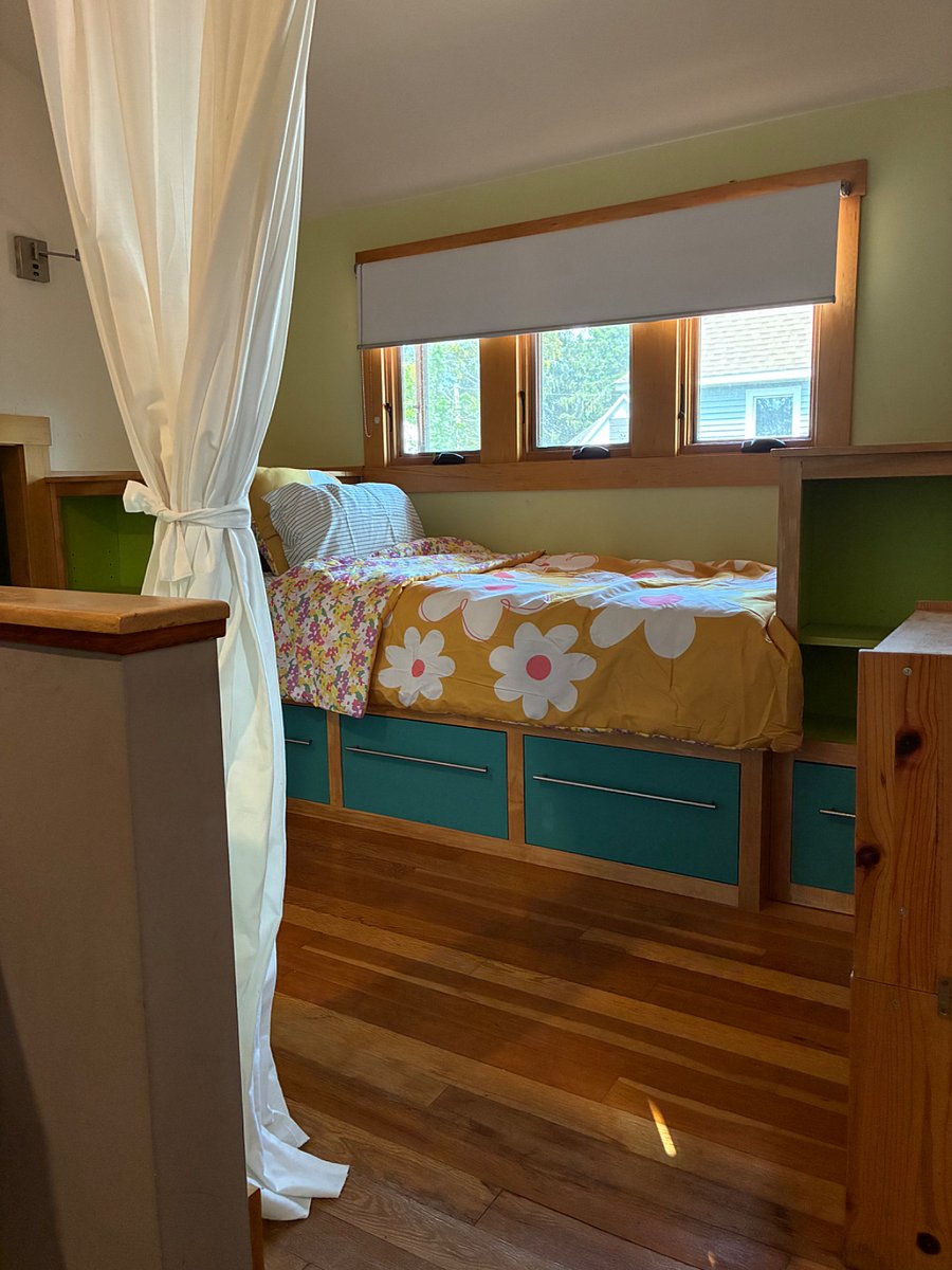Twin bed and storage under dormer windows.