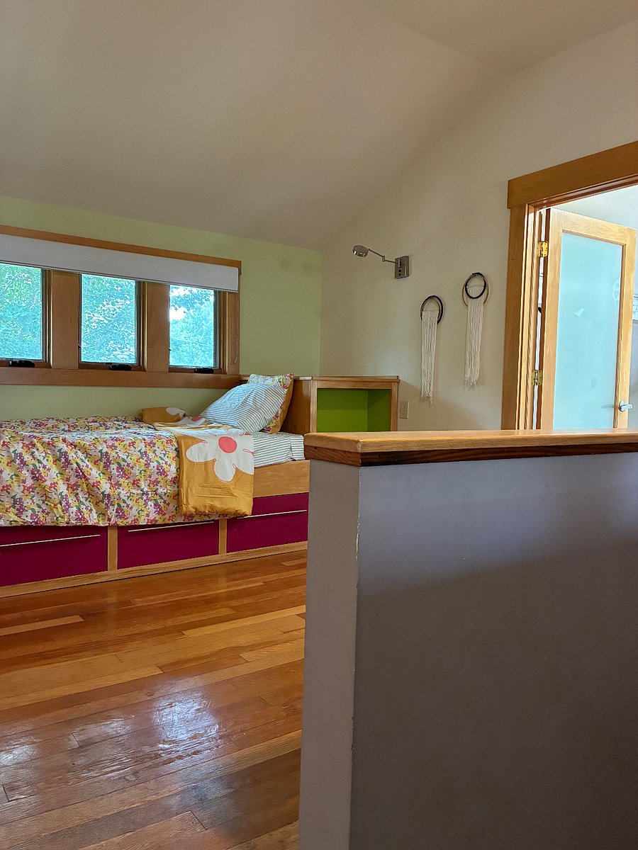 Twin bed and storage, with view of door to master bedroom.