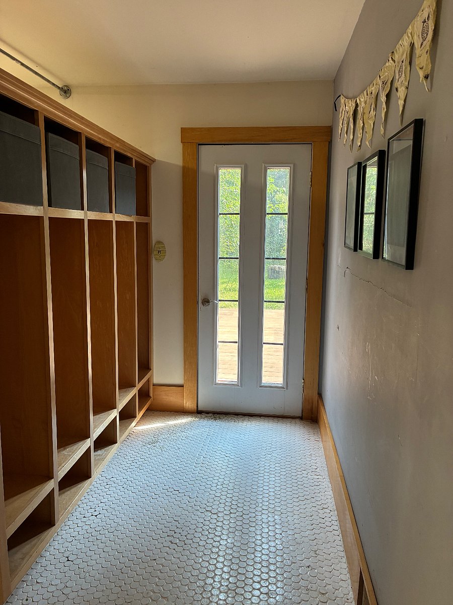 Door to the backyard from the sun room: coat racks and shoe storage (as well as cube storage above) make this built-in room divider beautiful and useful.