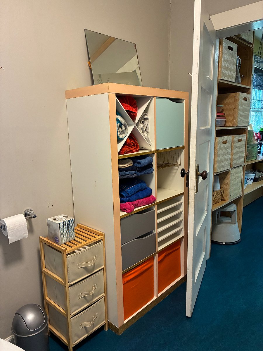 Linens and bathroom storage; door to kitchen.