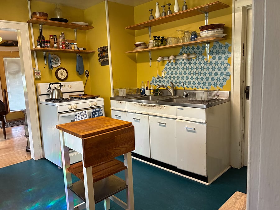 Kitchen with view to front room; sink includes built-in water filter tap.