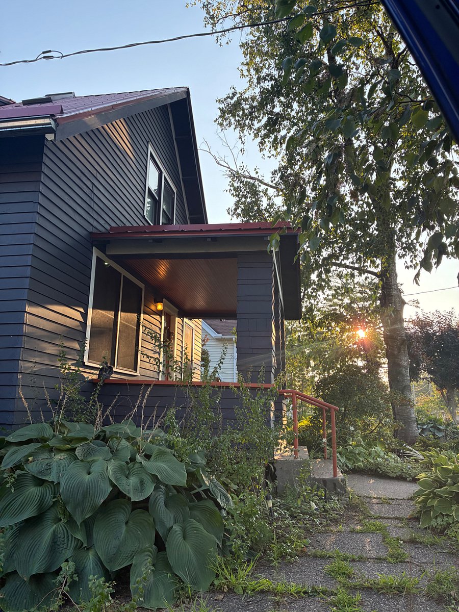 View of porch from the driveway at golden hour.