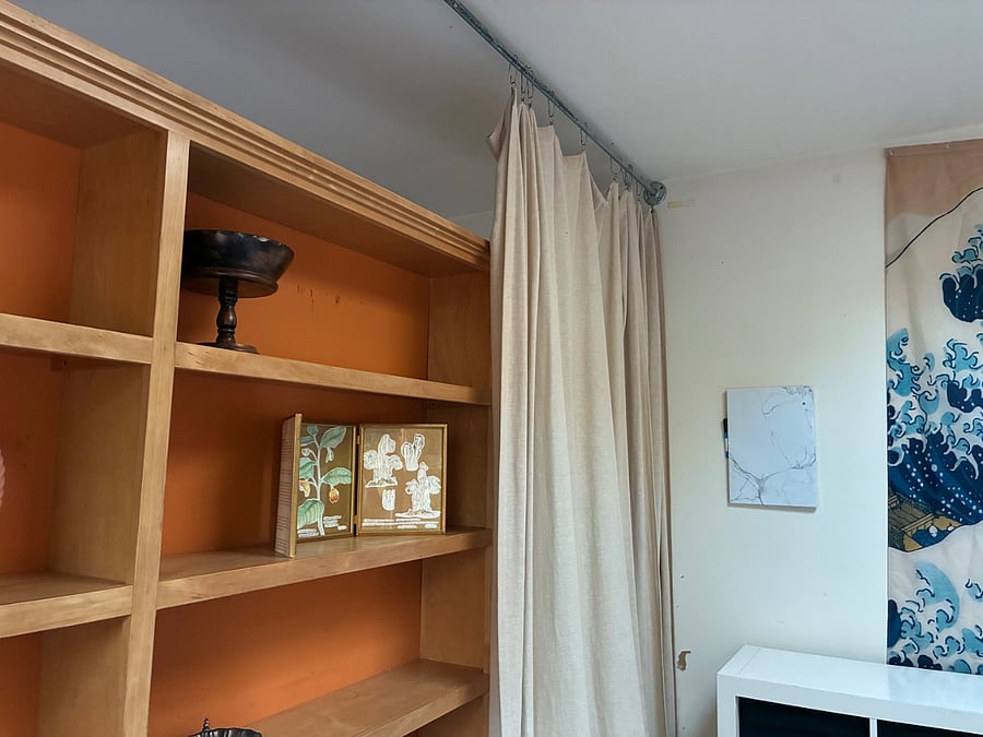 The sun room is graced by bountiful storage, skylights, curtains, and decor.