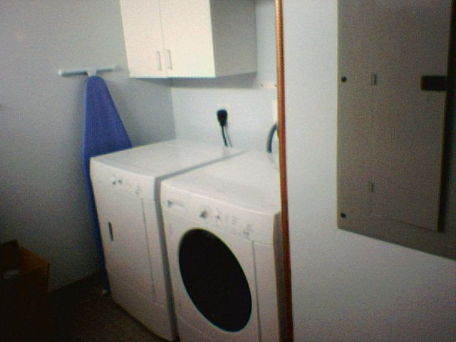 Small laundry room is located in the condo itself.