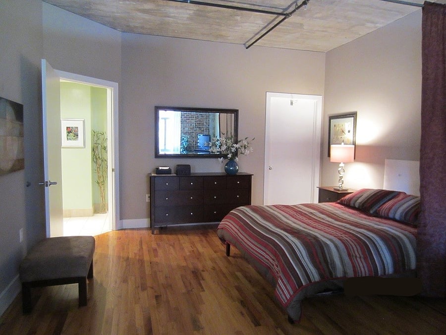 Bed area can be divided from TV area by an optional drape.