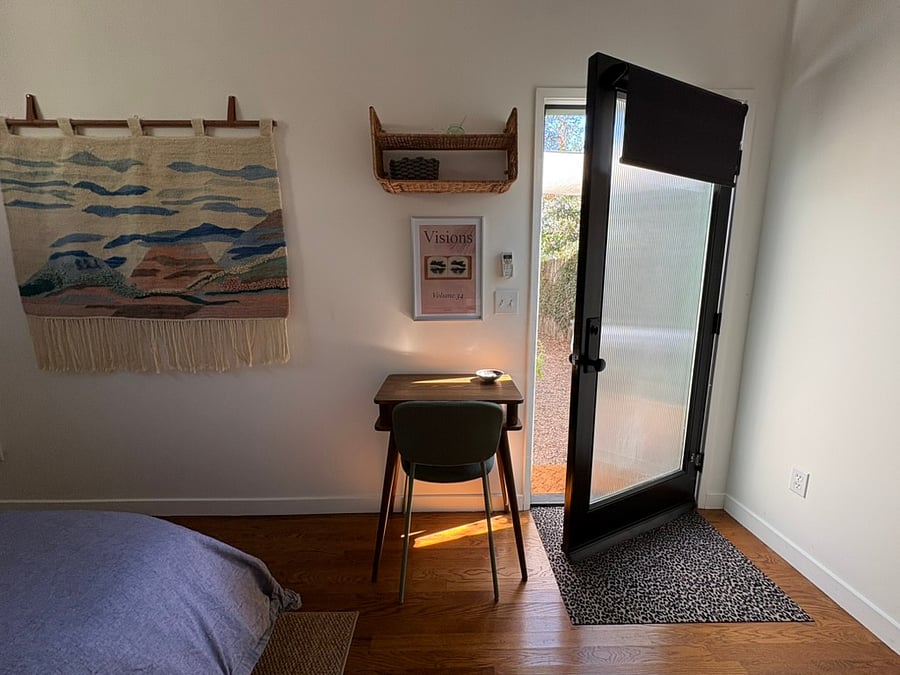 Small desk looks out onto shared patio.