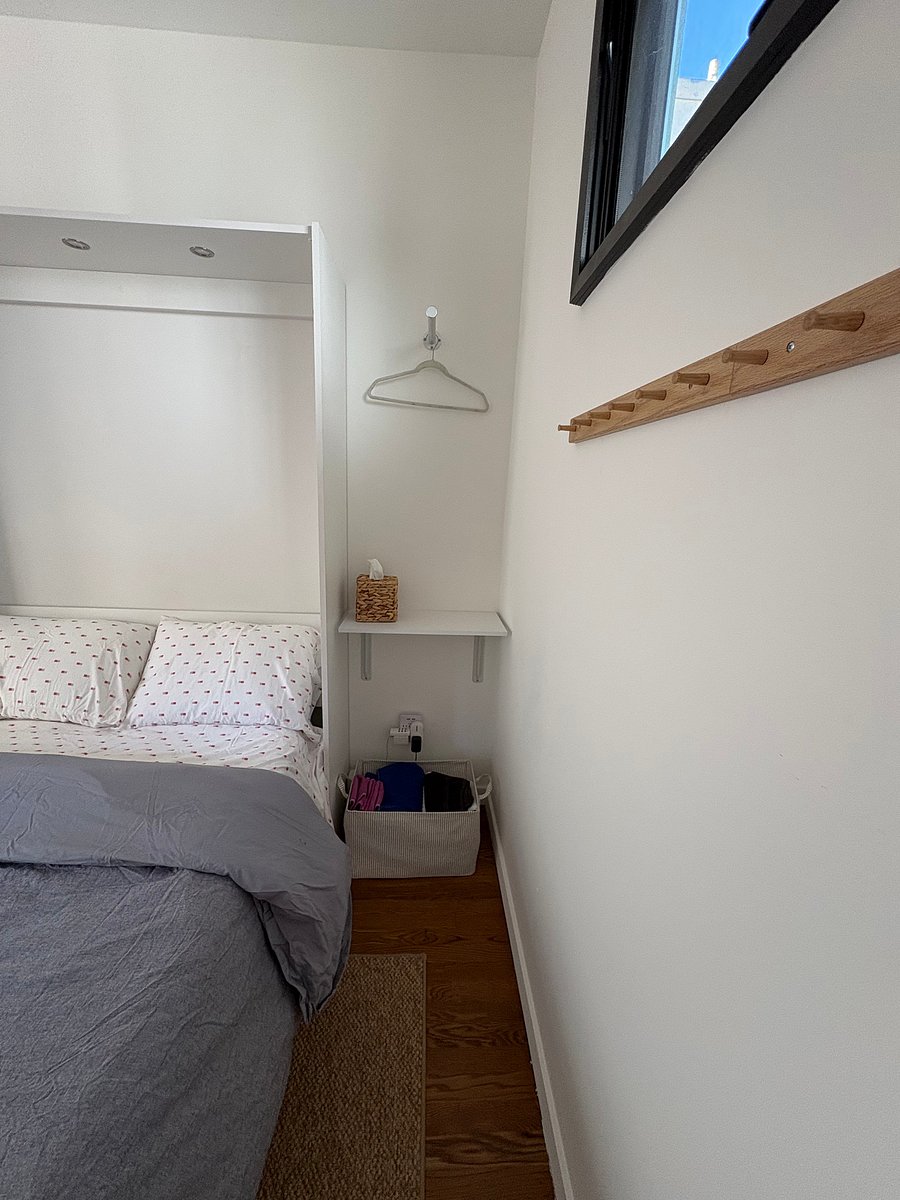 Nook to place your hanging clothes, spot to store your suitcase under the shelf, and row of hooks