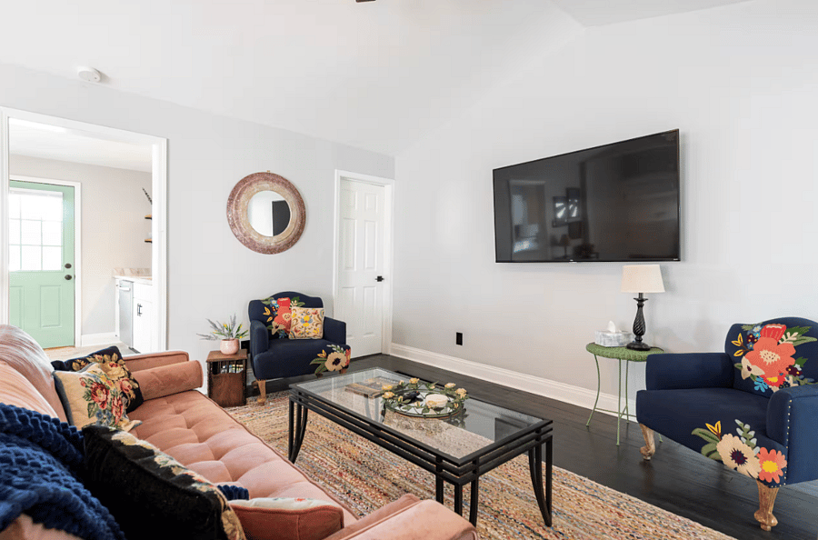 Living and dining area equipped with table for 4, plenty of seating, smart TV, dry bar and more.