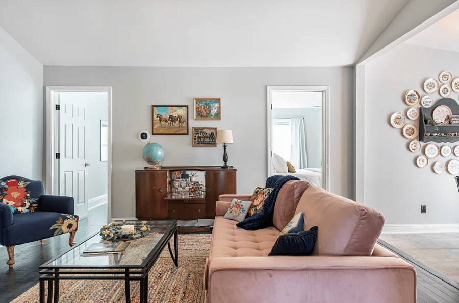Living and dining area equipped with table for 4, plenty of seating, smart TV, dry bar and more.