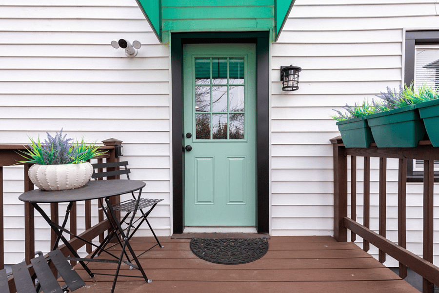 Side porch entrance with on property parking for one car.