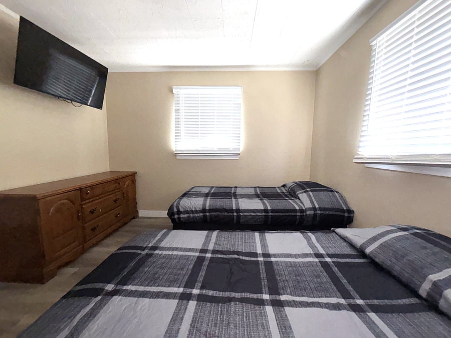Bedroom #1 w/ 2 twin beds, smart TV, closet, & extra sheets available
