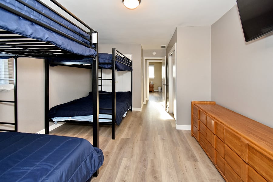 Bedroom #2 w/ 1 bunk bed, 1 full bed, 1 twin bed, smart TV, closet, & extra sheets available