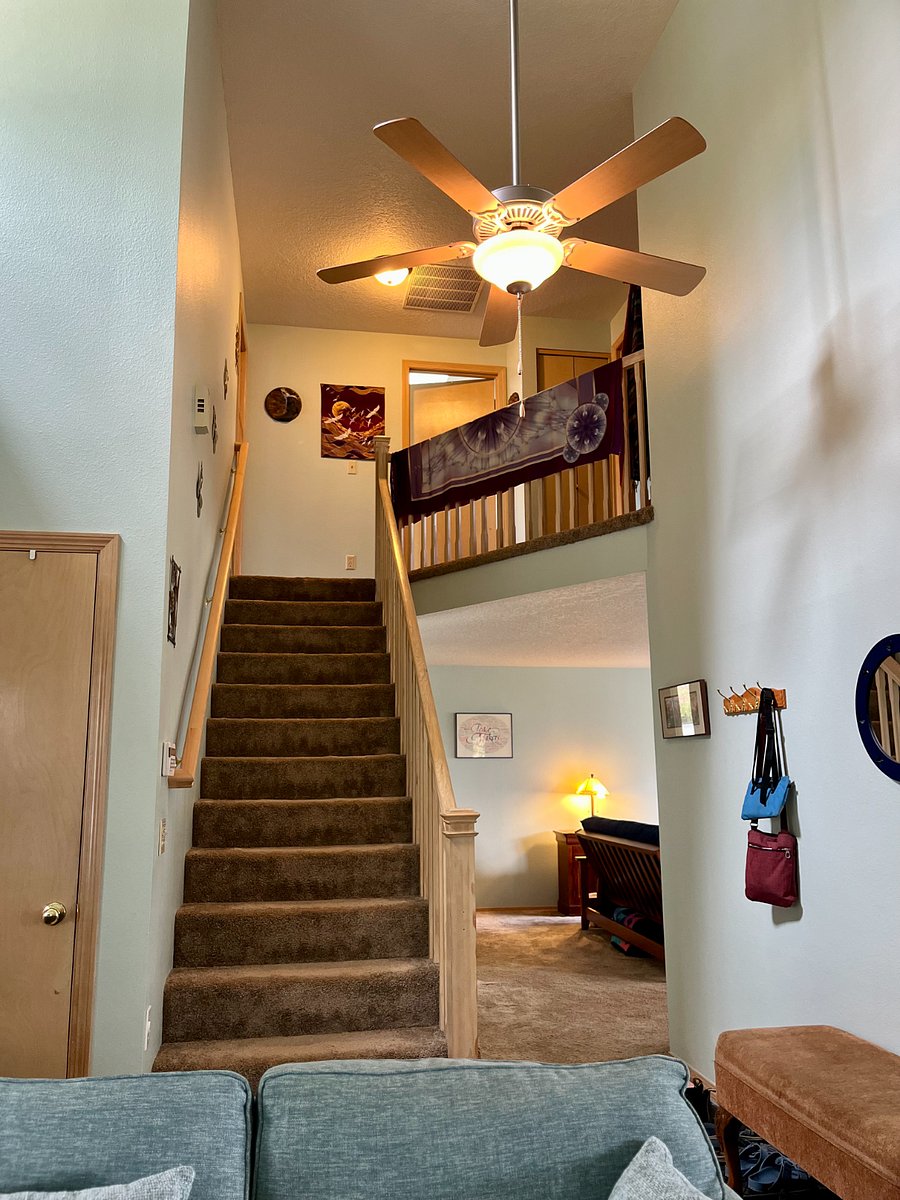 stairs with banisters to bedrooms
