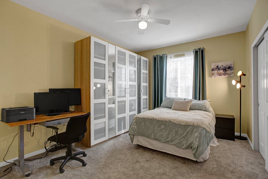Secondary bedroom with desk and computer monitors