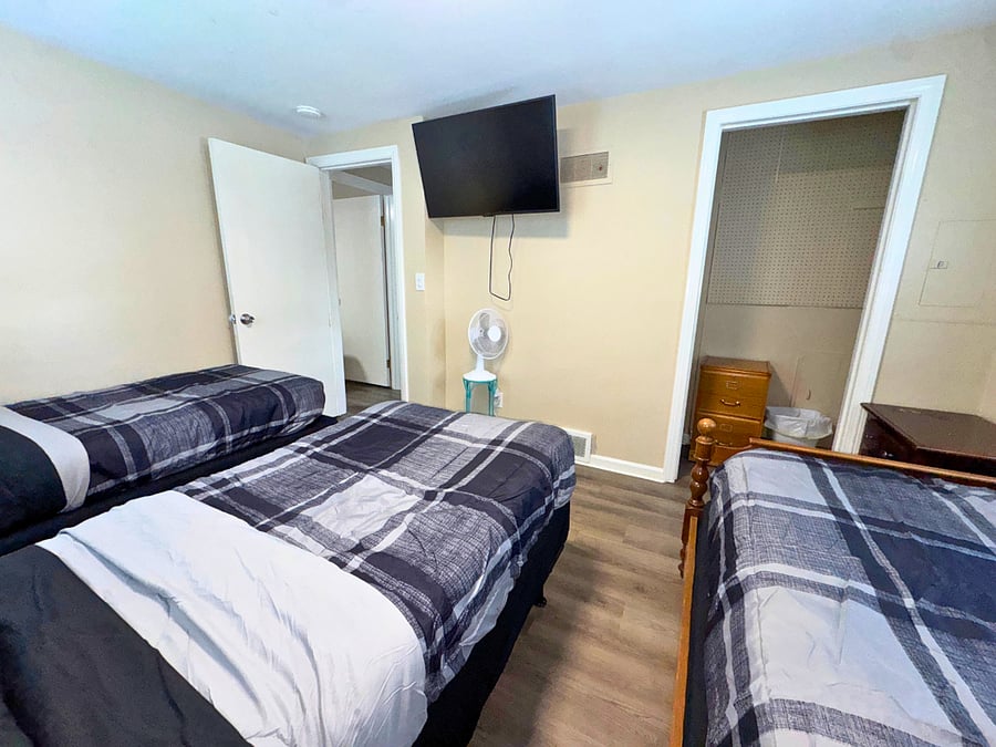 Bedroom #1 w/ 3 twin beds, smart TV, closet, & extra sheets available