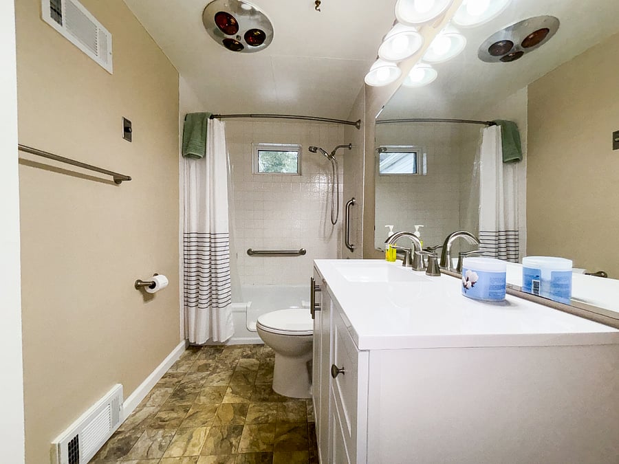 Bathroom w/ full-size tub & shower includes toilet paper, hand soap, & towels