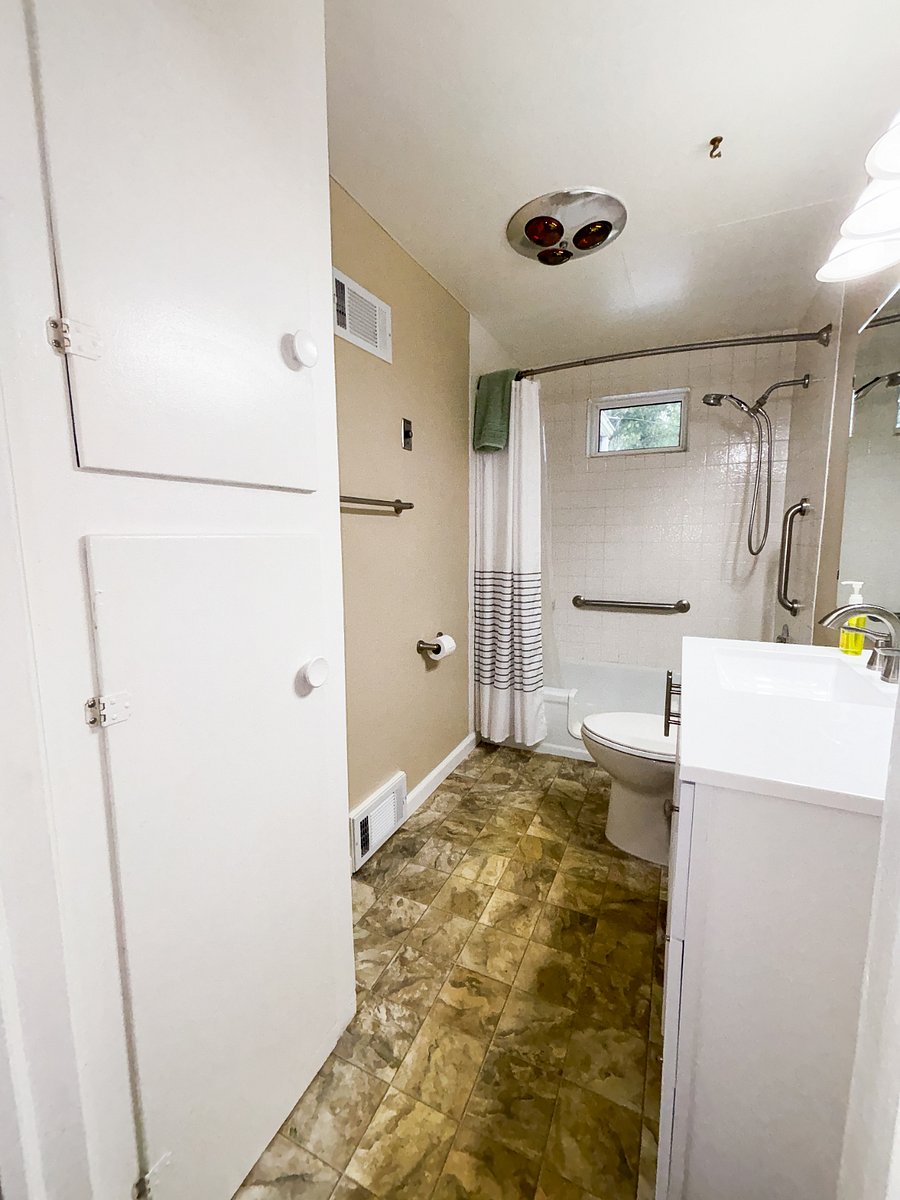 Bathroom w/ full-size tub & shower includes toilet paper, hand soap, & towels