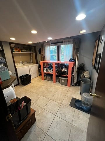 Laundry room featuring two folding areas, washer and dryer, and mud-room sink. This also stores tools and paint, and other home repair items. 