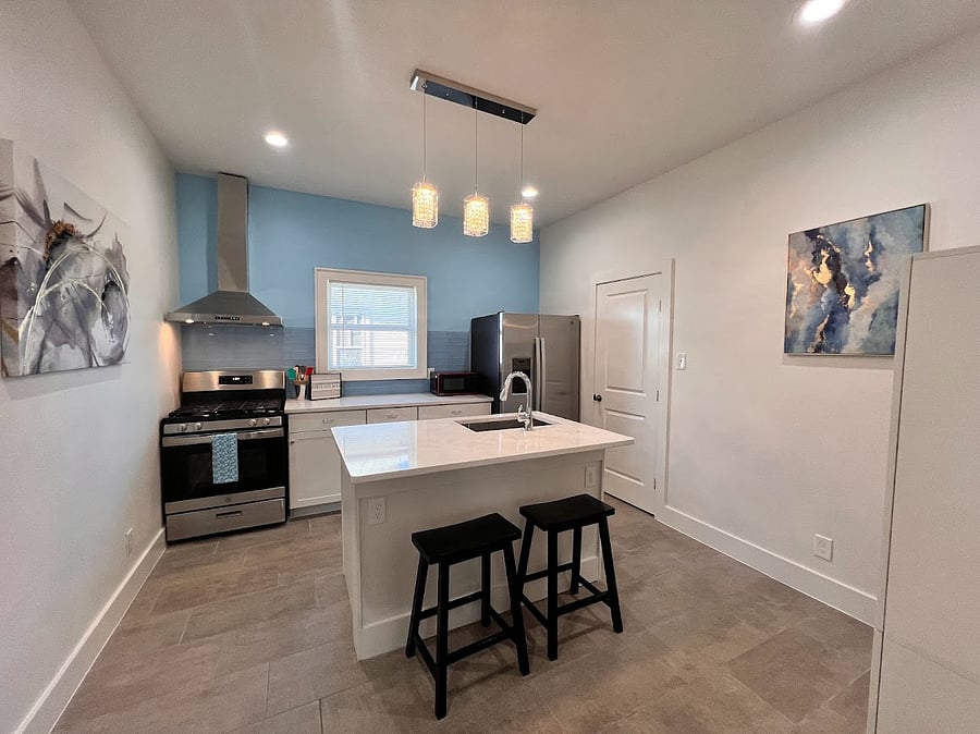Features full-size kitchen appliances, a compact microwave, and a convenient in-island dishwasher.