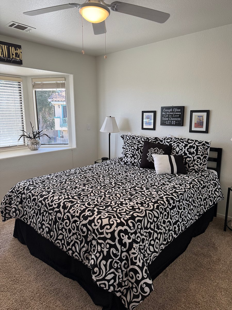 Guest bedroom has mirrored closet sliding doors and extra pillows, Ceiling fan installed