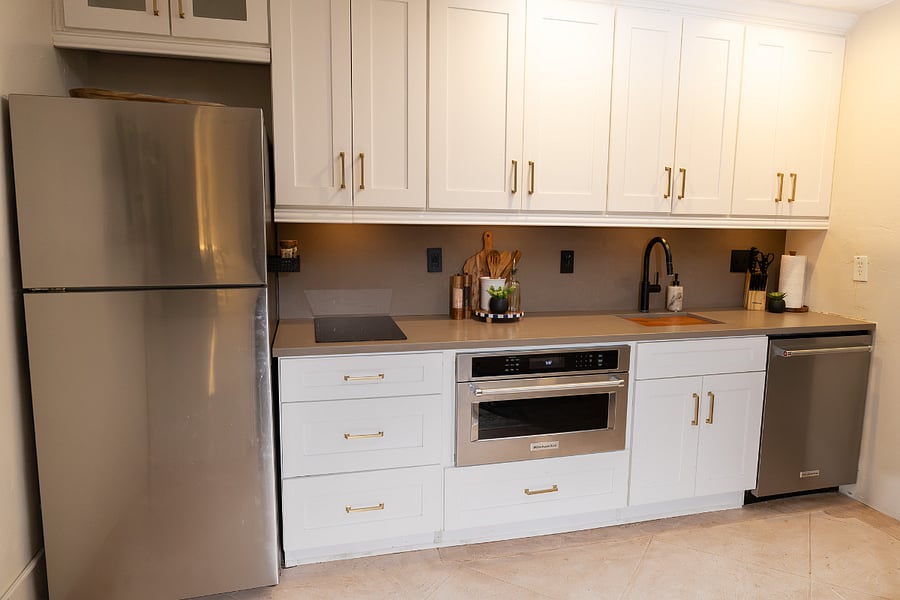 Fully stocked, modern kitchen featuring KitchenAid appliances, a dual induction cooktop, and All-Clad cookware.