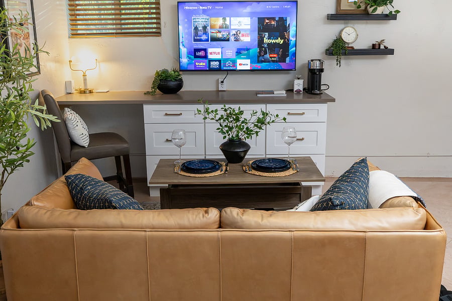 Relax on the real leather sofa with a Smart TV featuring complimentary Hulu +_ Live TV.