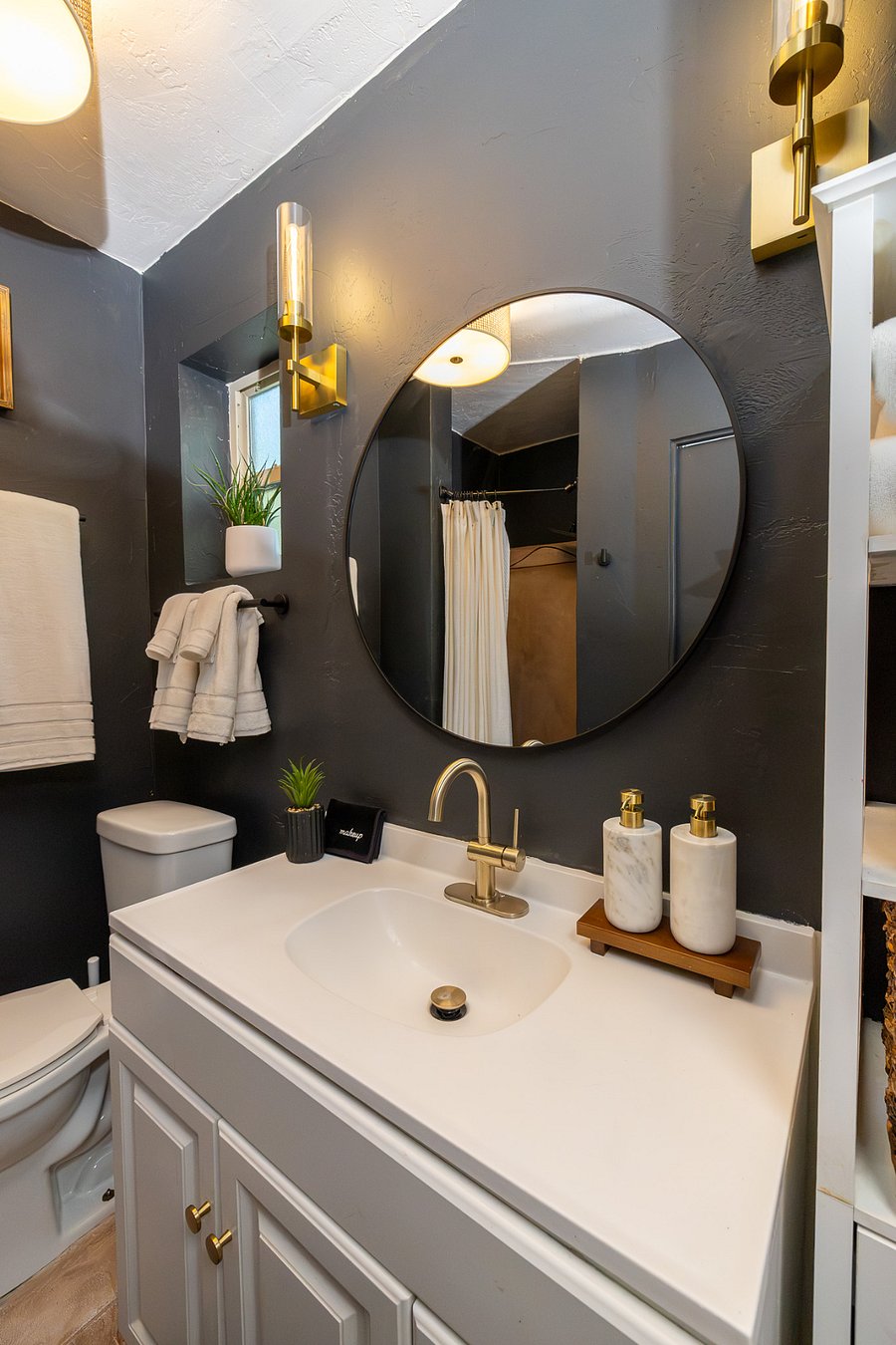 Sleek, modern bathroom setup featuring cozy plush towels and a rainfall shower.