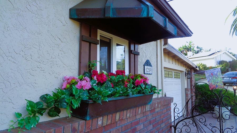 Copper accents with beautiful patina line your entryway.