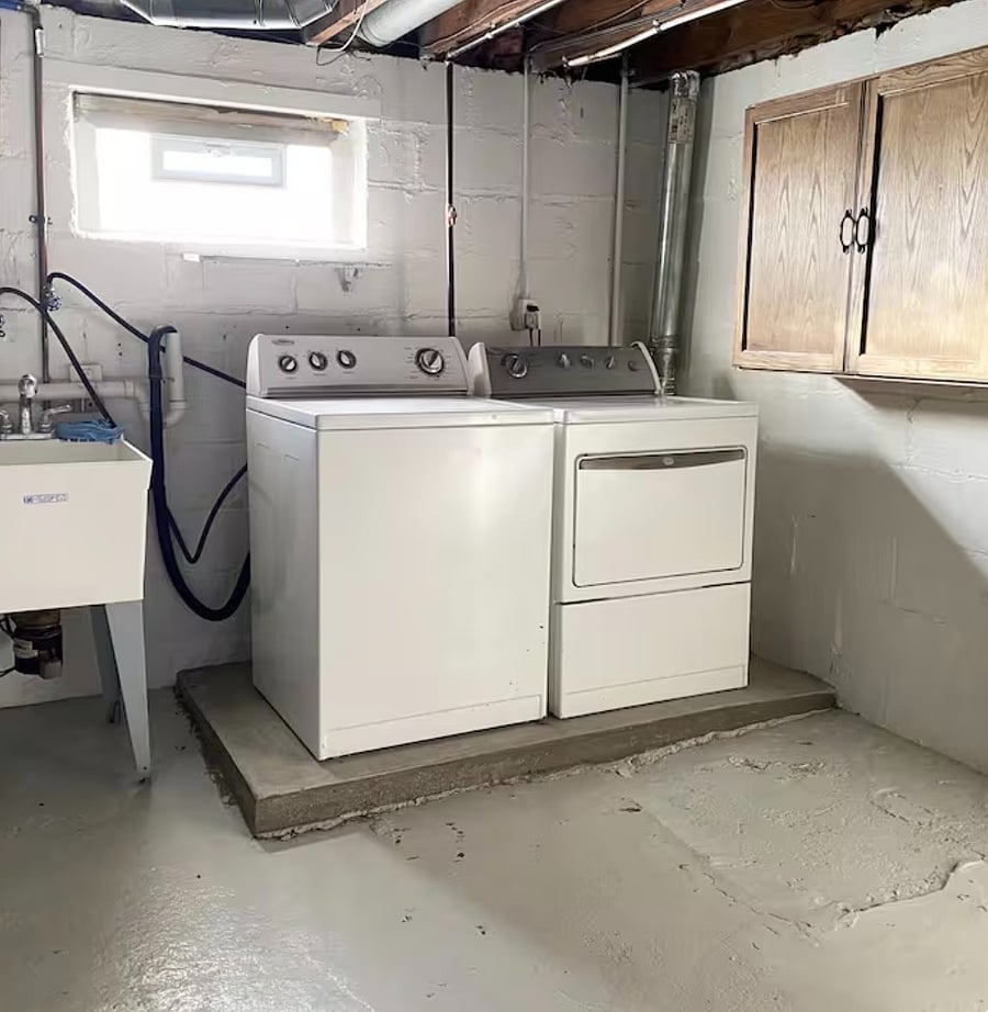 Convenient in-home laundry area with washer, dryer and utility sink.