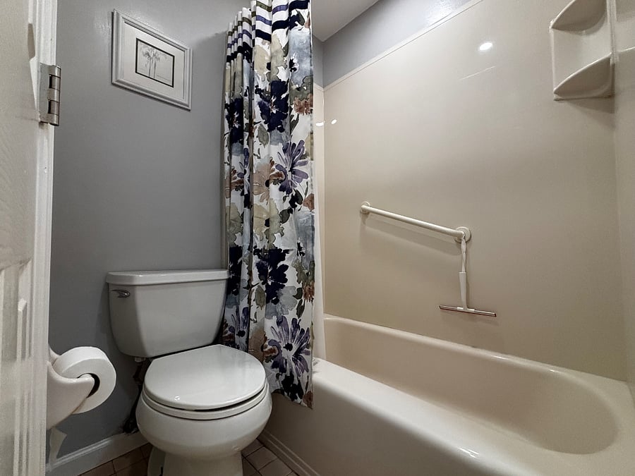 Bathroom with full tub and safety bar