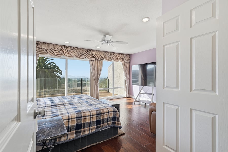Primary bedroom featuring a large balcony with panoramic views, ensuite bathroom with walk-in shower and custom walk-in closet