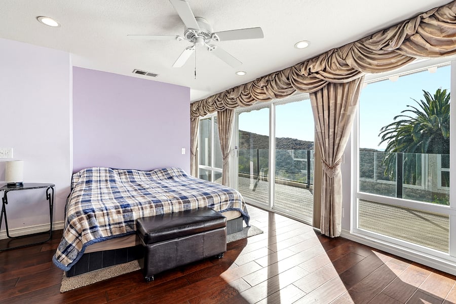 Primary bedroom featuring a large balcony with panoramic views, ensuite bathroom with walk-in shower and custom walk-in closet