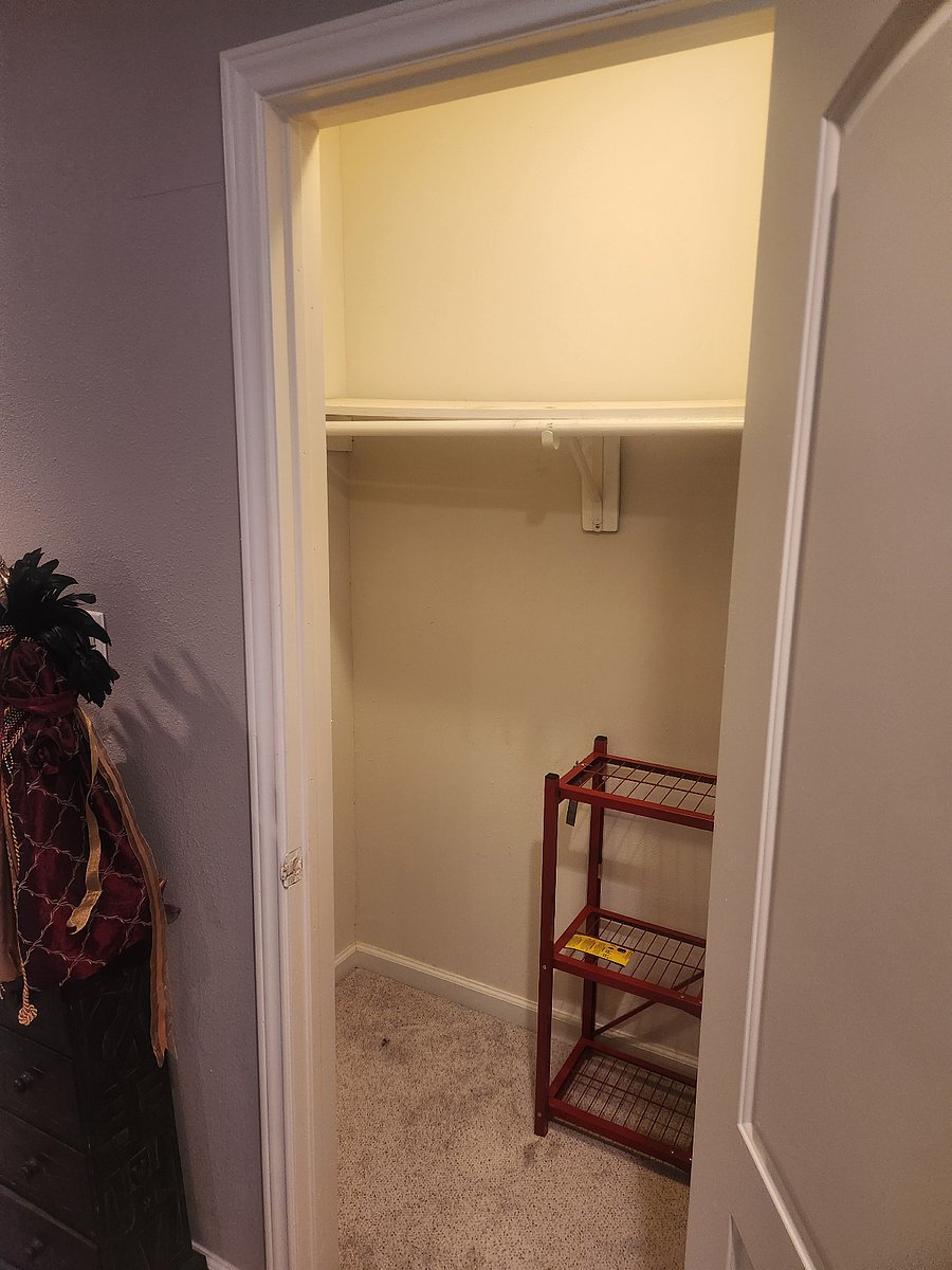 Spacious walk-in closet with storage space