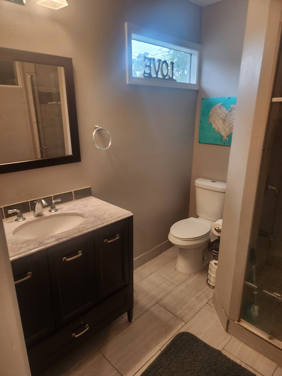 Private bathroom with granite counters and tile