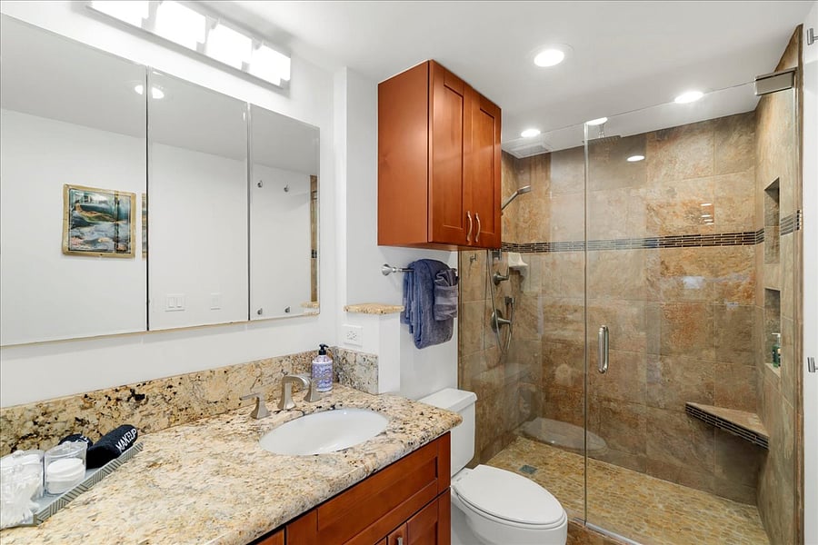 A spa-like vanity and custom tiled walk-in shower. Clean, modern, and beautifully updated for a refreshing end to your day.