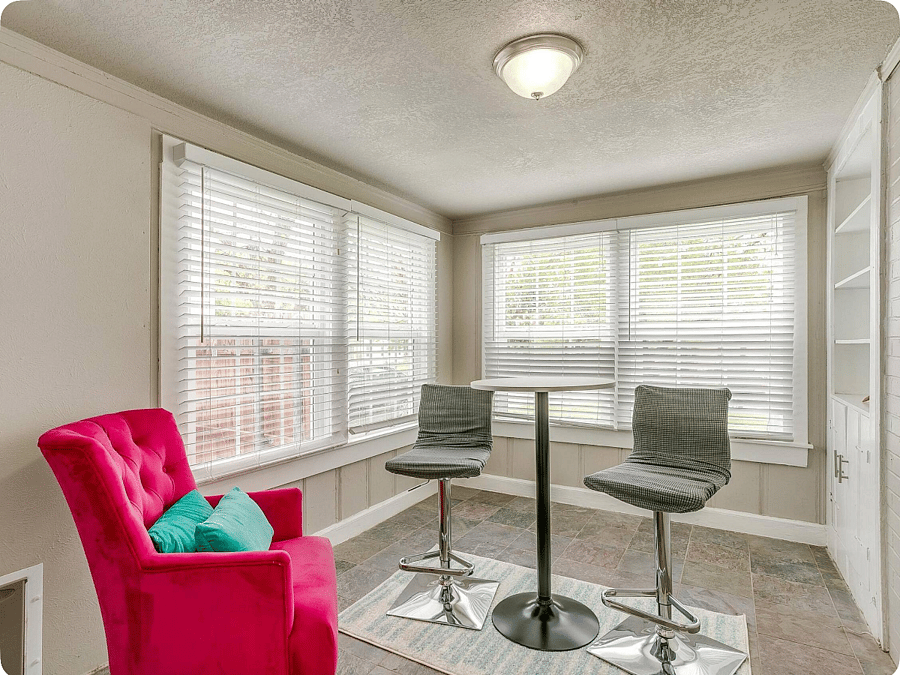 Bright sunroom with seating & wall-to-wall windows  1st floor.