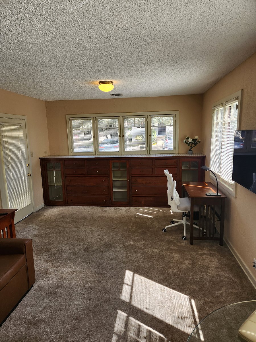 Wall-to-wall cabinets with writing desk that includes Wi-Fi, Bluetooth stereo, and ergonomic chair.