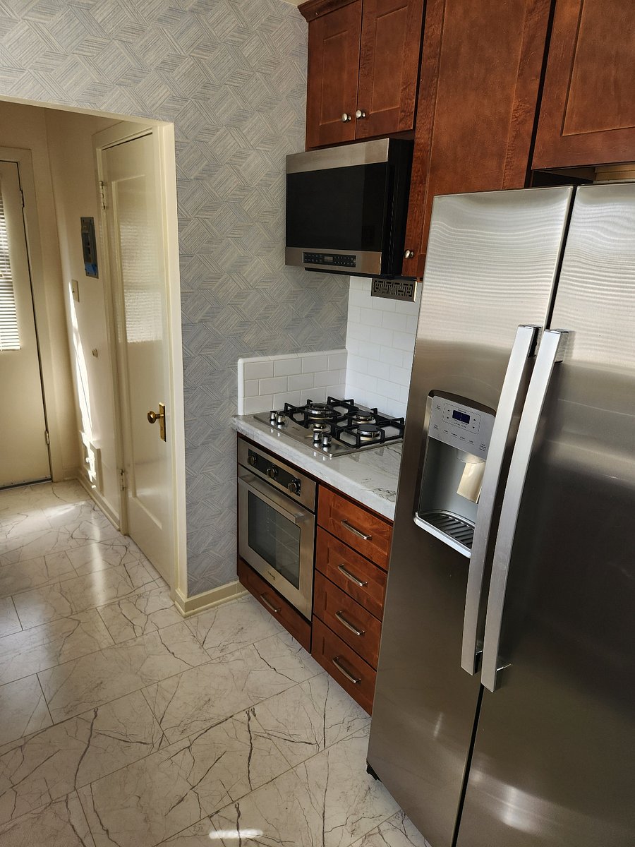 Drop-in 4-burner stainless gas cooktop over the built-in oven w/ broiler, and an overhead microwave with stove vent.