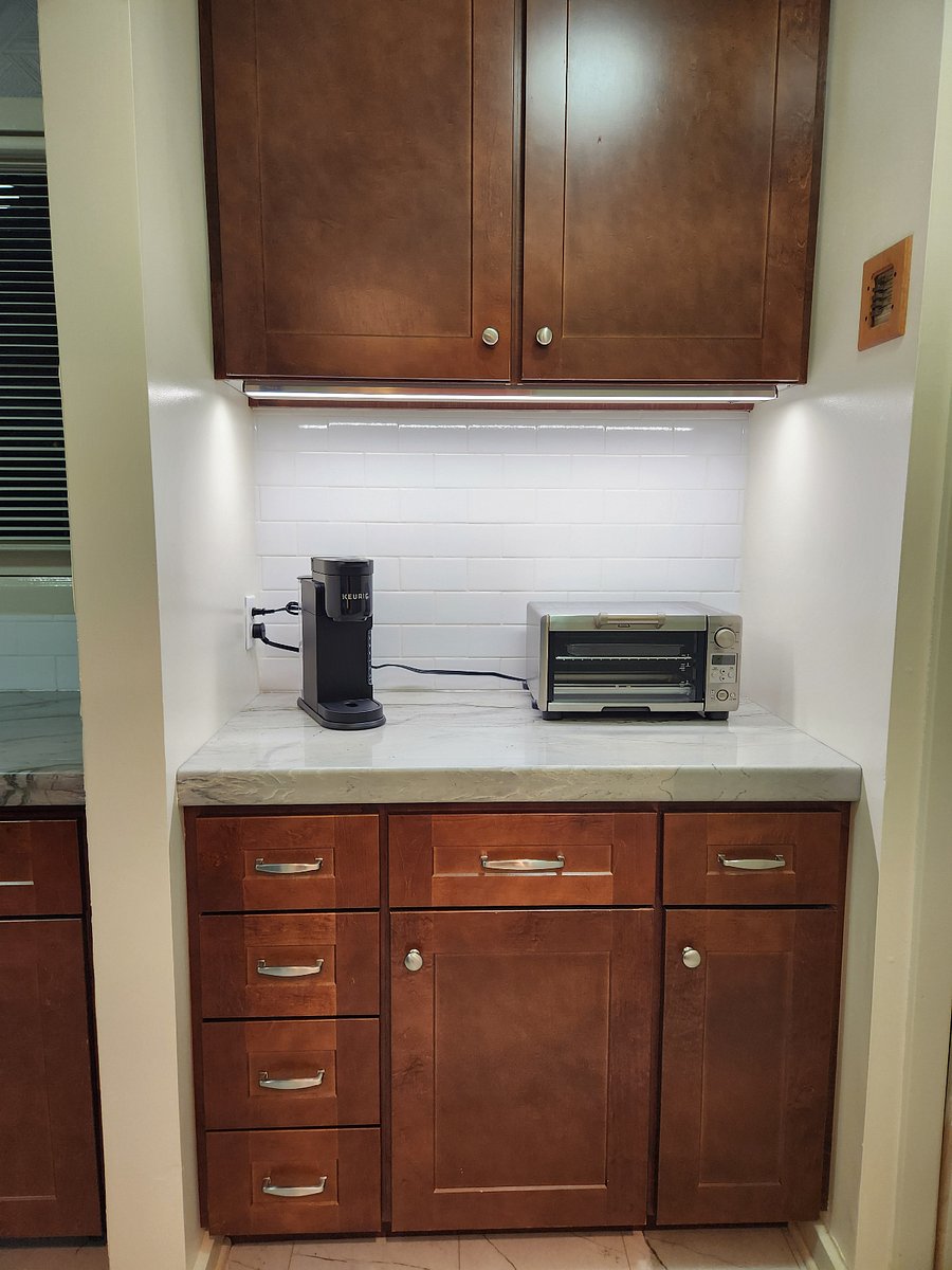 Butler's pantry includes a pullout trash container with dual containers, a pullout pots 'n pans rack, a Keurig coffee maker, and a Breville toaster oven.
