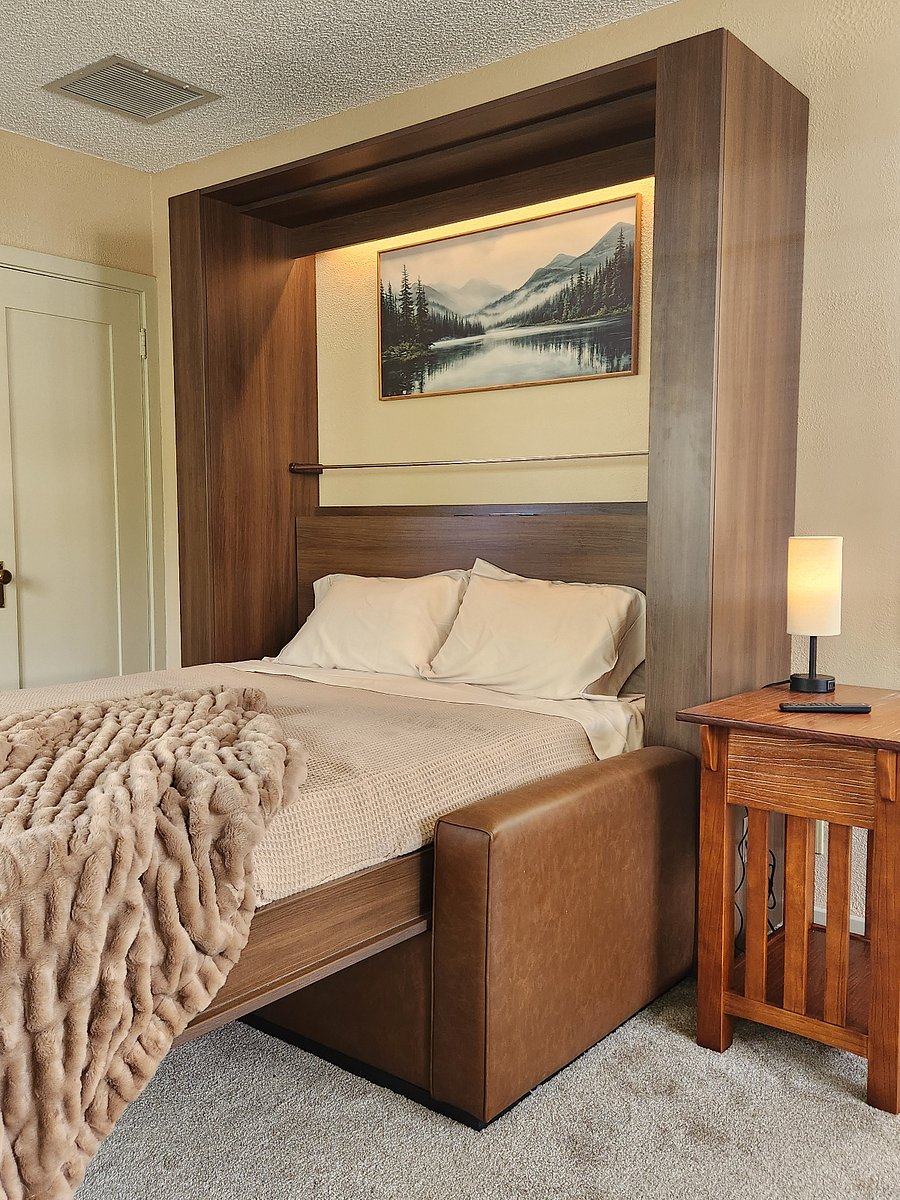 Sheets and blanket remain on the bed and pillows are placed on shelf below picture when transforming into a couch.