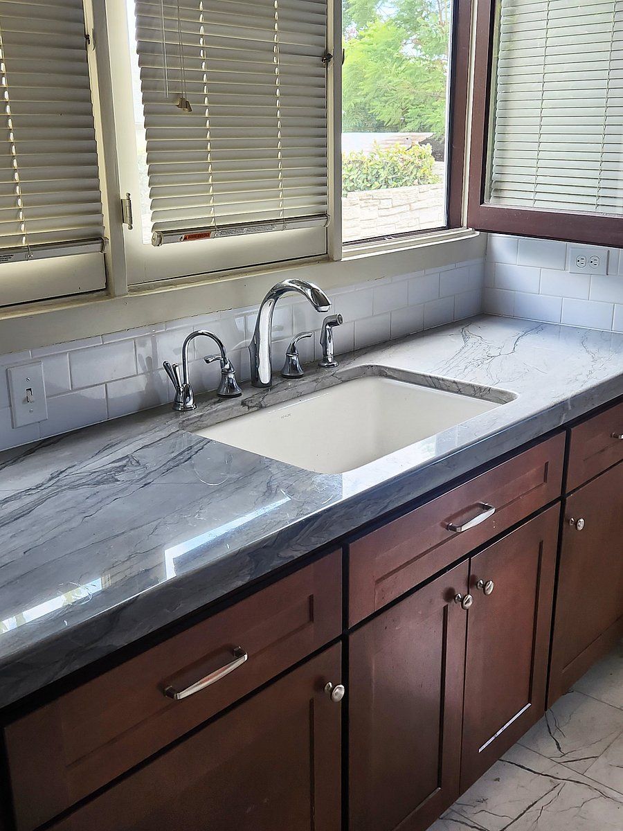 Quartzite countertop over deluxe maple cabinets with a 3-rack Bosch dishwasher, large porcelain sink including disposer and instant filtered hot & cold water.