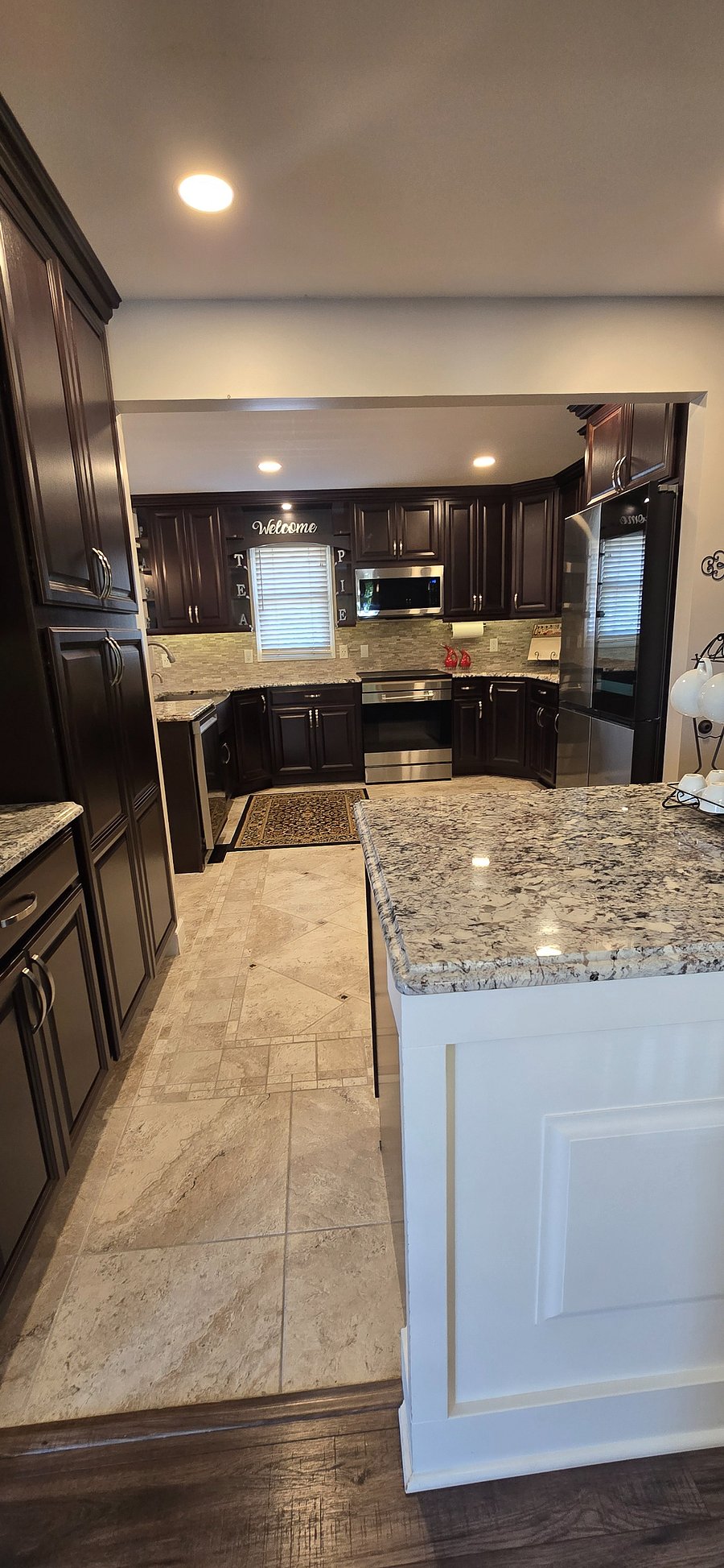 Kitchen area featuring appliances and fridge with tablet